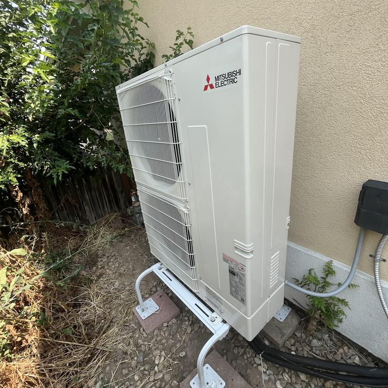 Mitsubishi heat pump outdoor unit installed by wall Mitsubishi heat pump outdoor unit installed by wall