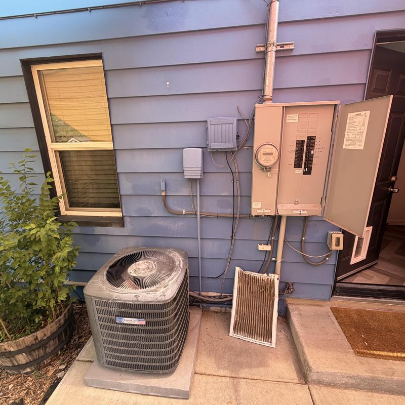 Outdoor air conditioner condenser with dirty filter near breaker panel Outdoor air conditioner condenser with dirty filter near breaker panel