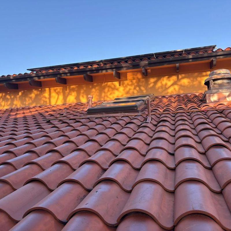 Tile roof with skylight on residential home Tile roof with skylight on residential home