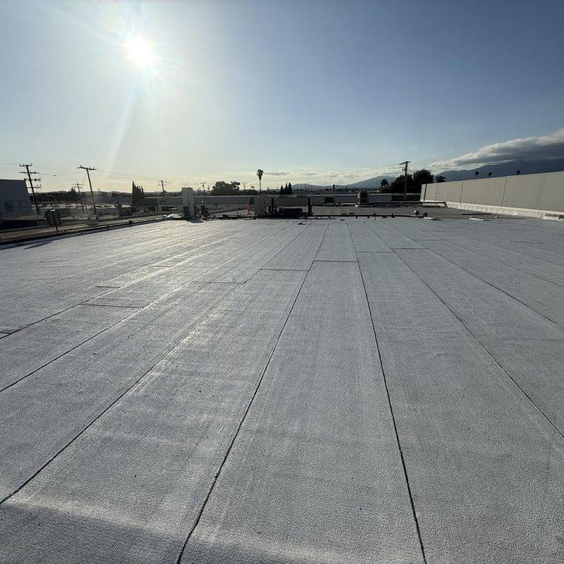 Flat roof membrane installation on commercial building Flat roof membrane installation on commercial building