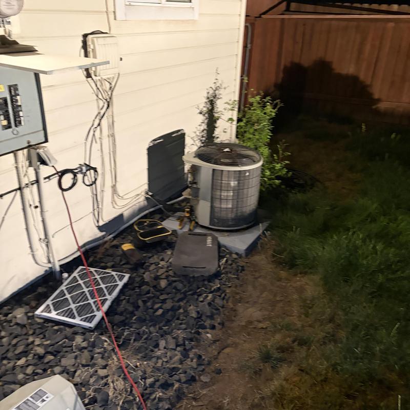 Outdoor AC condenser unit with tools on ground Outdoor AC condenser unit with tools on ground