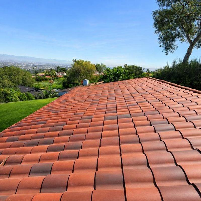 Clay tile roof installation with scenic backyard view Clay tile roof installation with scenic backyard view