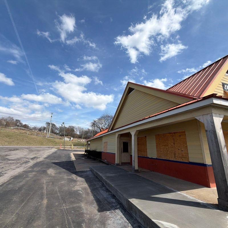 Metal roof with hail damage and boarded windows