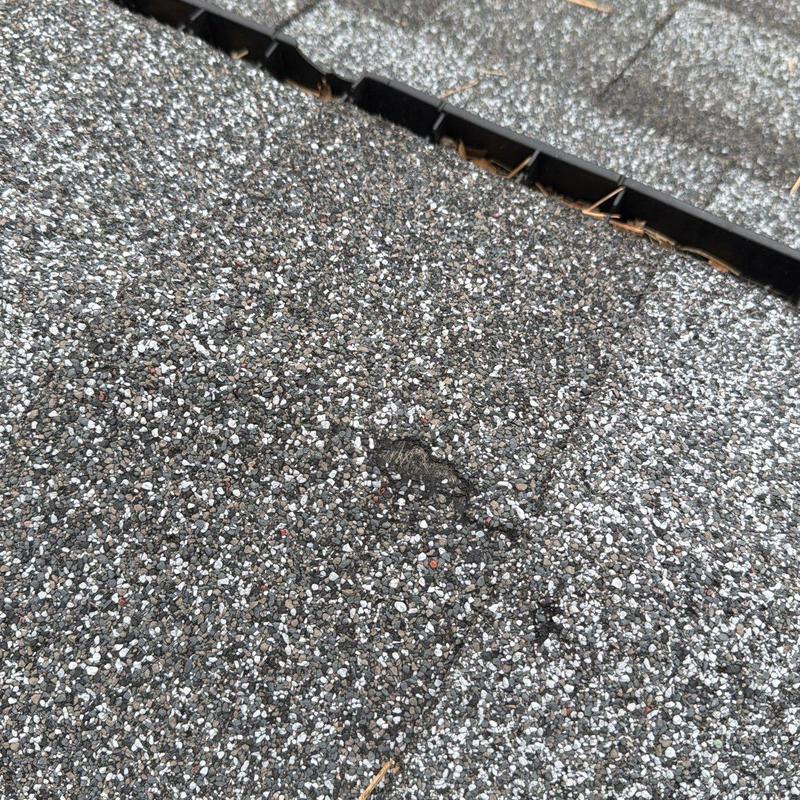 Roof shingles with hail damage close-up detail