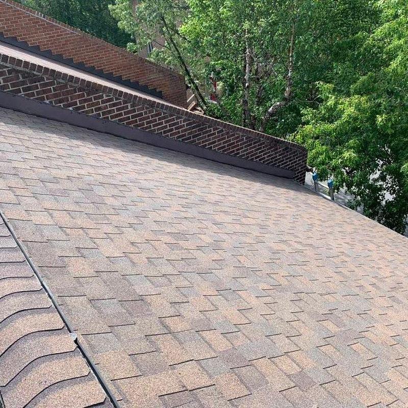 Shingle roof surface inspection with brick chimney nearby Shingle roof surface inspection with brick chimney nearby