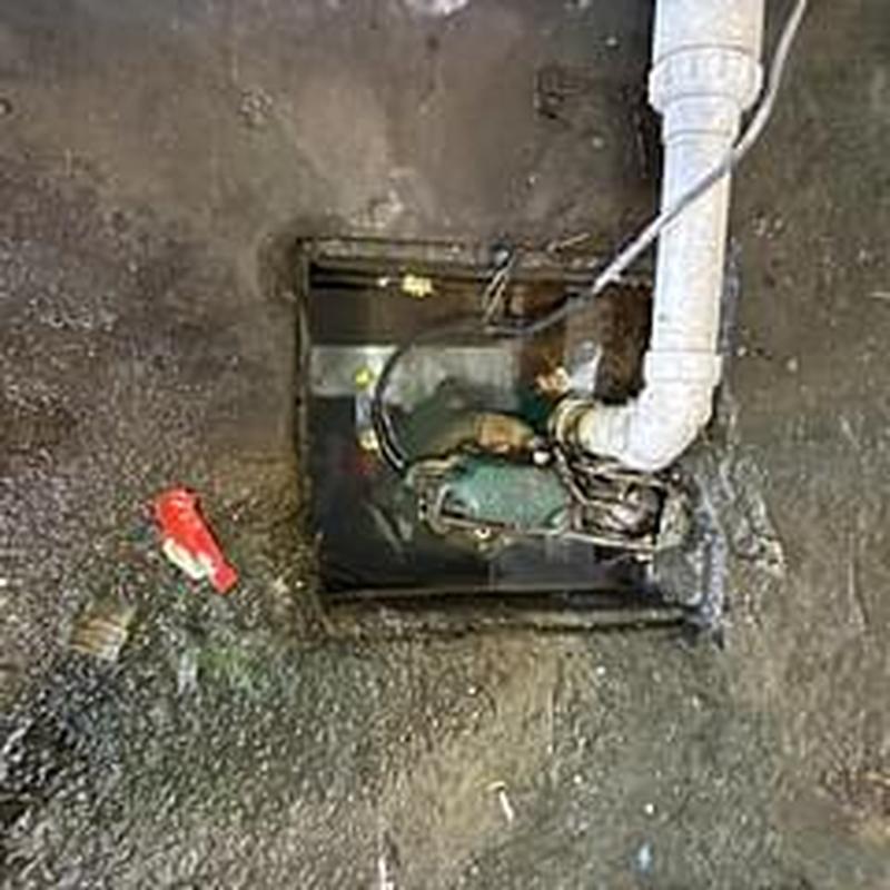 Sump pump discharge line extension in stairwell