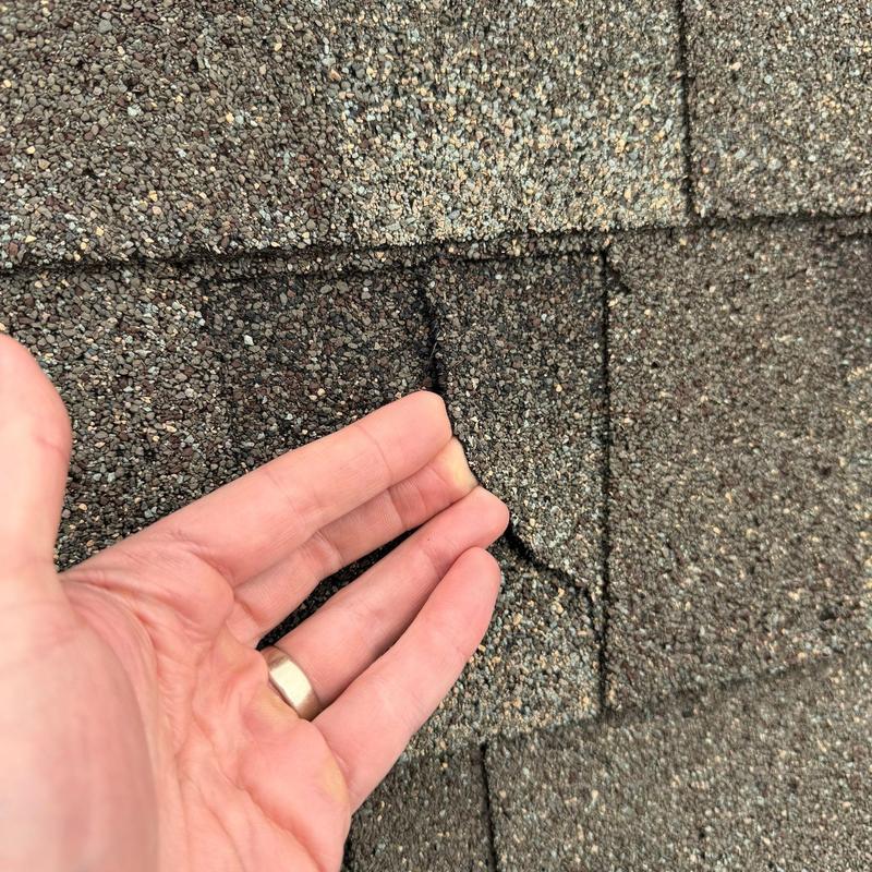 Asphalt roof shingles with hail damage close-up