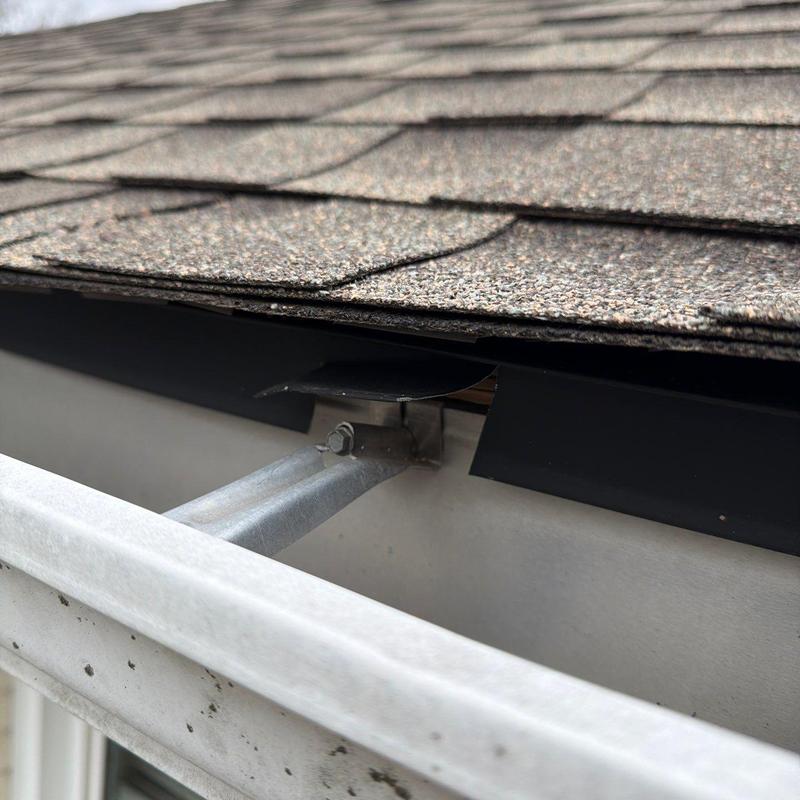 Asphalt shingle roof and metal gutter flashing detail