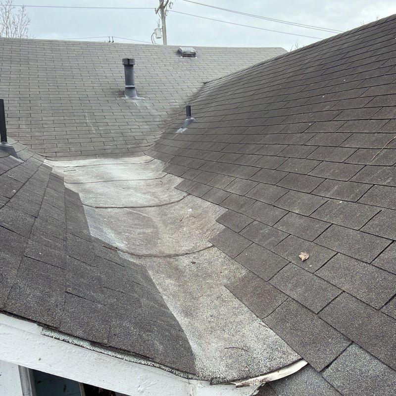 Roof valley with worn underlayment and asphalt shingles