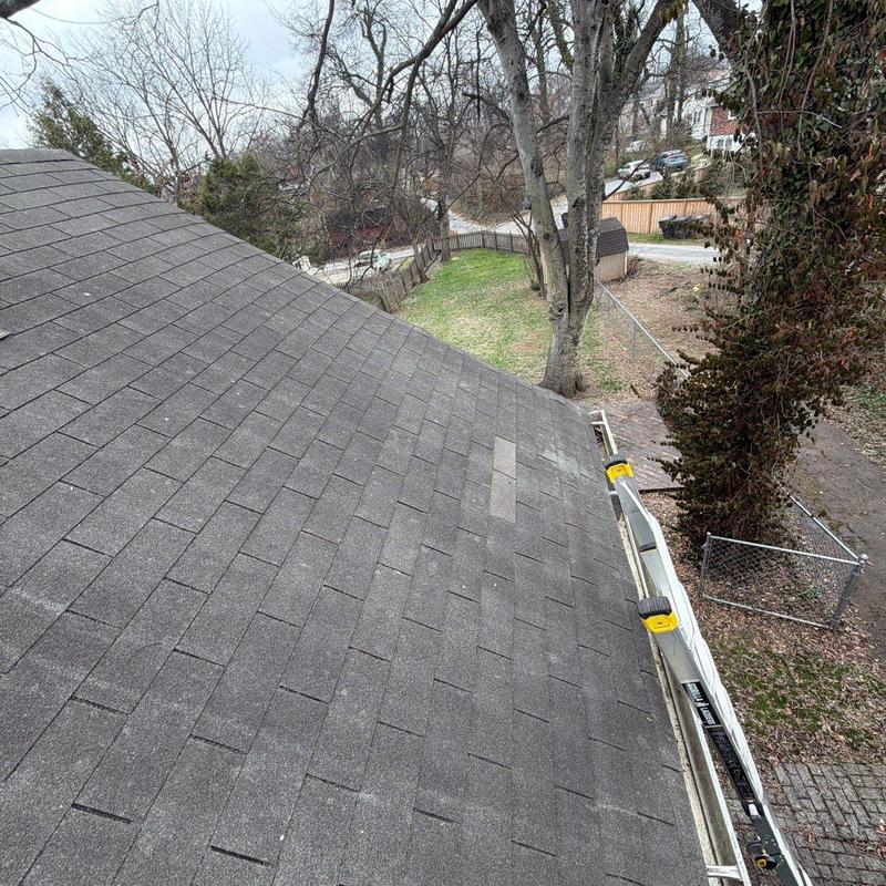 Asphalt shingle roof with ladder and gutter inspection