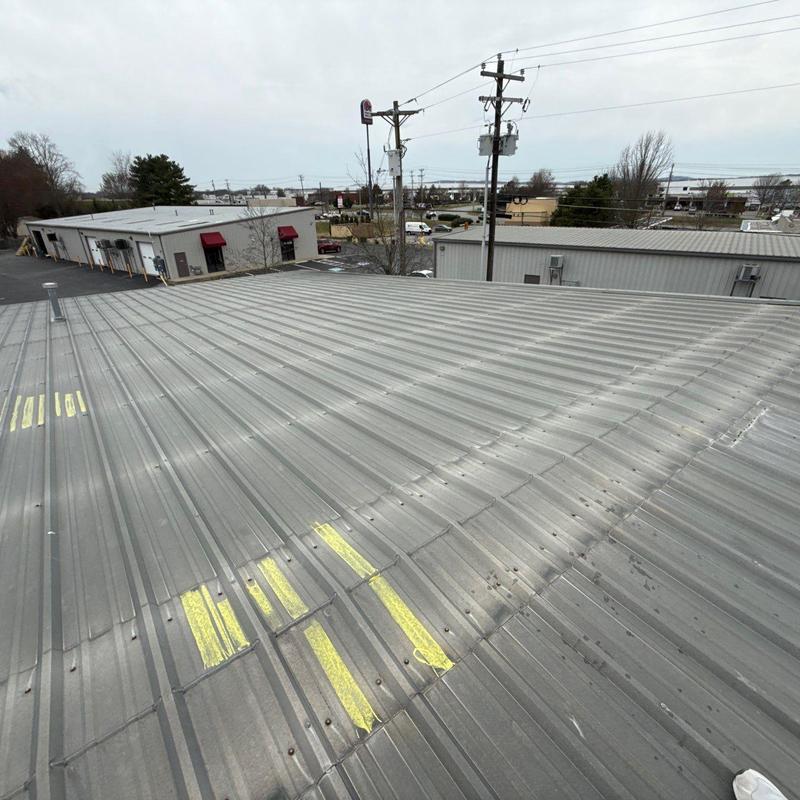 Metal roof panels with marked hail damage spots