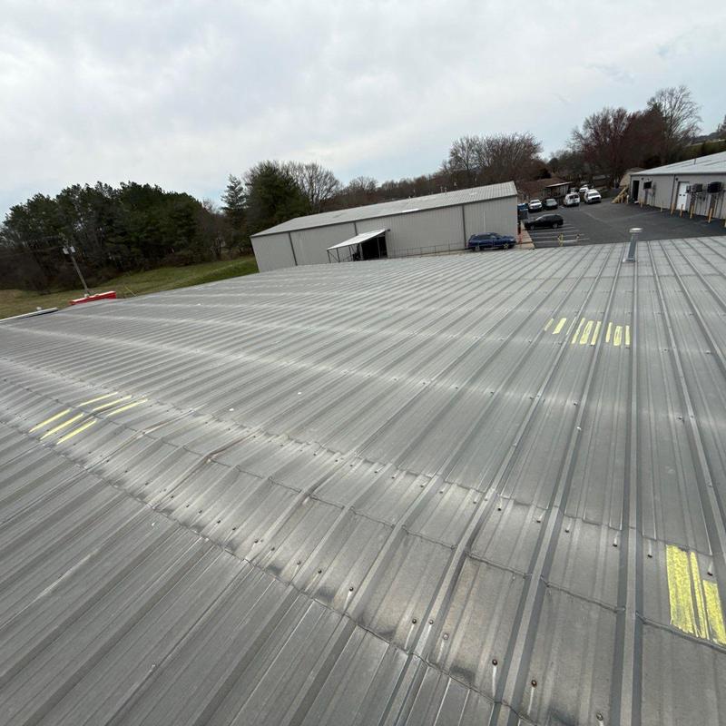 Metal roof panels with marked hail damage in Smyrna