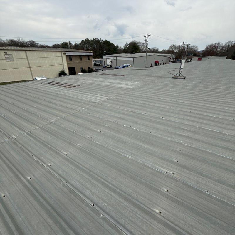 Metal roof panel with hail damage and repairs