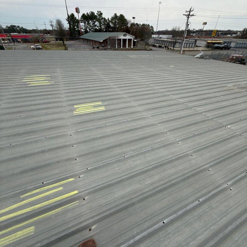 Metal roof panels with marked hail damage spots