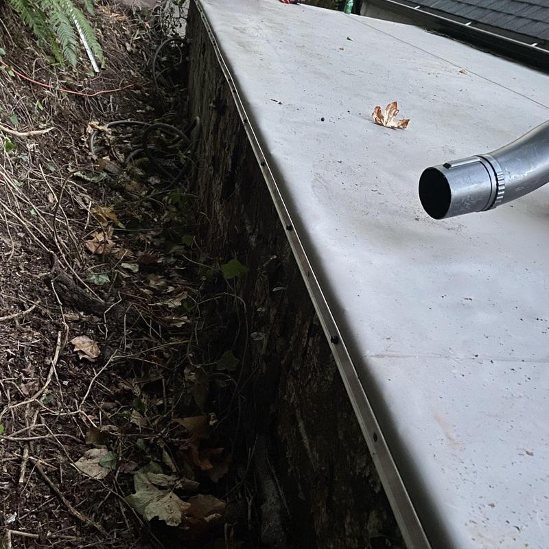 Sheet metal flashing at roof-to-wall transition