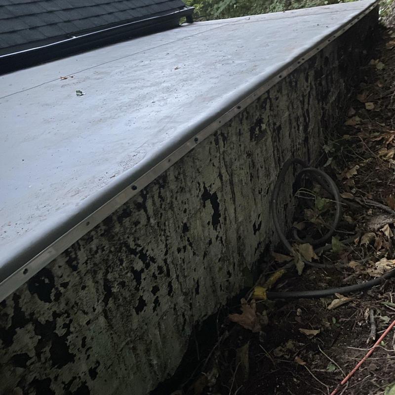 Sheet metal flashing at roof-to-wall transition