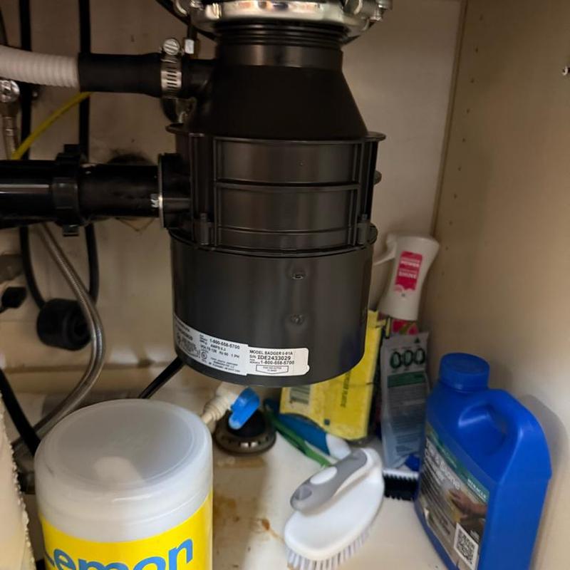 Garbage disposal unit installed under kitchen sink Garbage disposal unit installed under kitchen sink