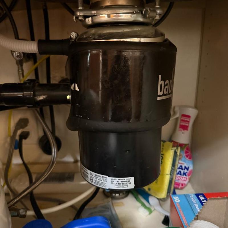 Garbage disposal unit installed under kitchen sink Garbage disposal unit installed under kitchen sink