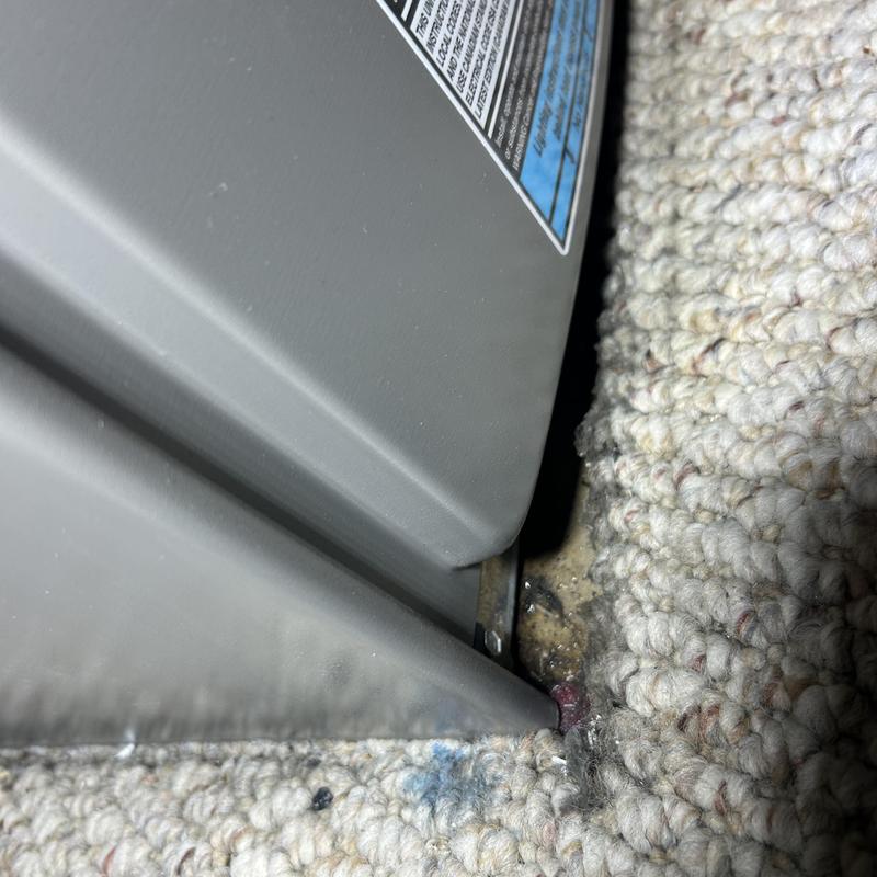 Furnace base with water leak on carpet edge Furnace base with water leak on carpet edge