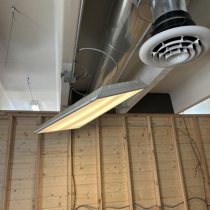 Commercial ceiling light fixture with duct vent nearby