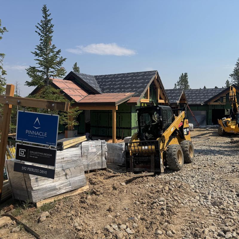 Asphalt shingle and metal roof under construction with equipment Asphalt shingle and metal roof under construction with equipment