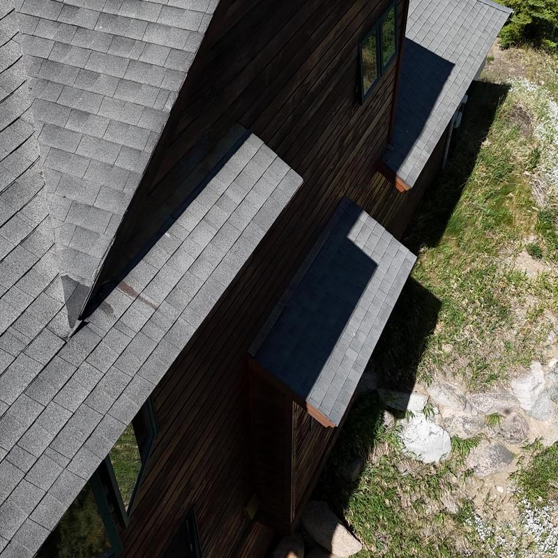 Asphalt shingle roof with wooden siding and windows Asphalt shingle roof with wooden siding and windows