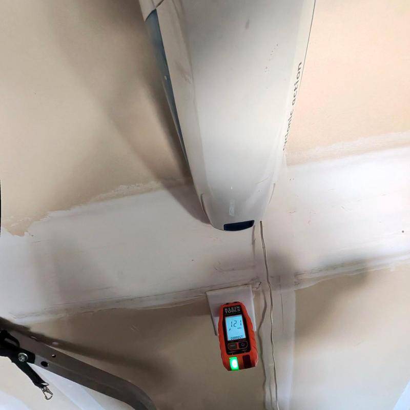 Voltage tester on ceiling-mounted garage door sensor Voltage tester on ceiling-mounted garage door sensor