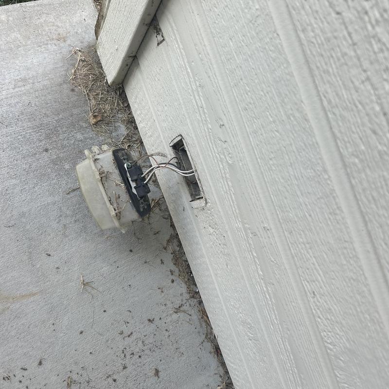Exterior electrical outlet with exposed wiring on wall Exterior electrical outlet with exposed wiring on wall