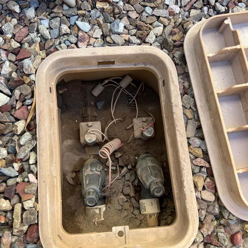 Irrigation valve box with wiring under plastic lid Irrigation valve box with wiring under plastic lid