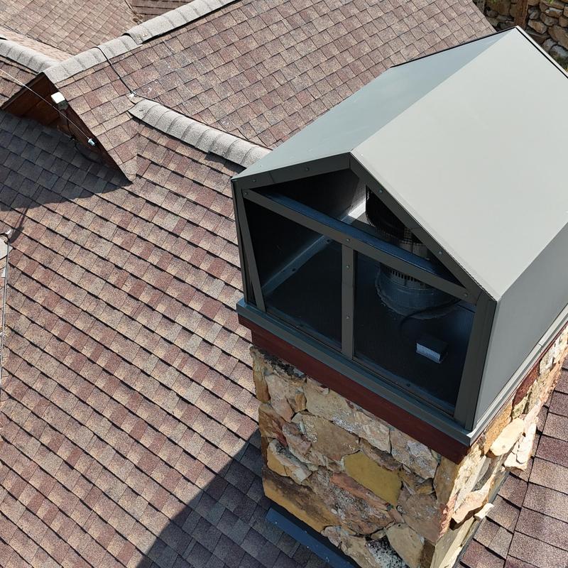 Asphalt shingle roof with chimney cap and gutters