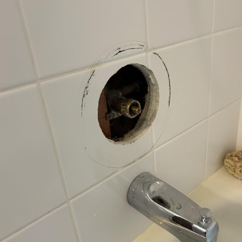 Shower valve fixture with cut tile wall exposure Shower valve fixture with cut tile wall exposure