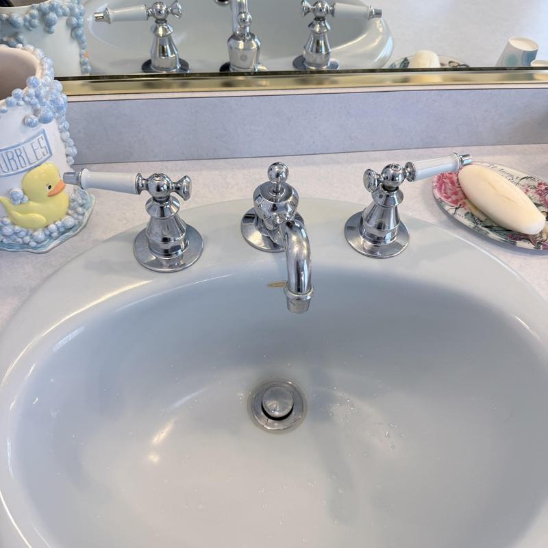 Double vanity faucet with white handles and chrome finish