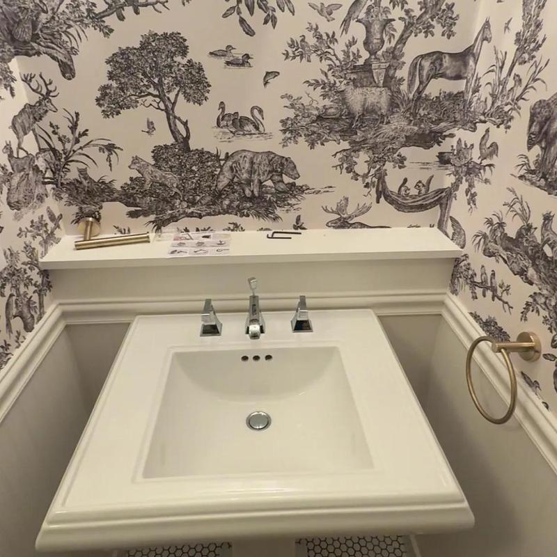 Bathroom sink and faucet with patterned wallpaper Bathroom sink and faucet with patterned wallpaper