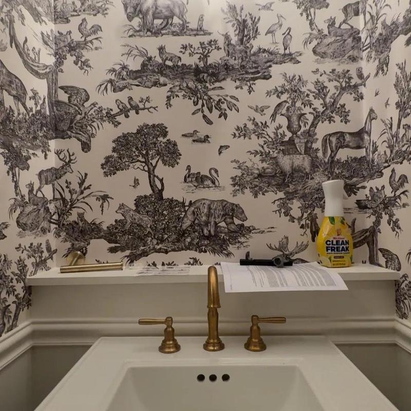 Brass bathroom faucet with decorative wallpaper backdrop Brass bathroom faucet with decorative wallpaper backdrop