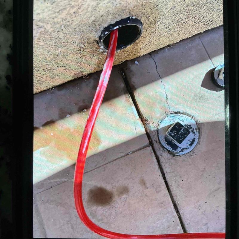 Kitchen cleanout drain with red plumbing snake