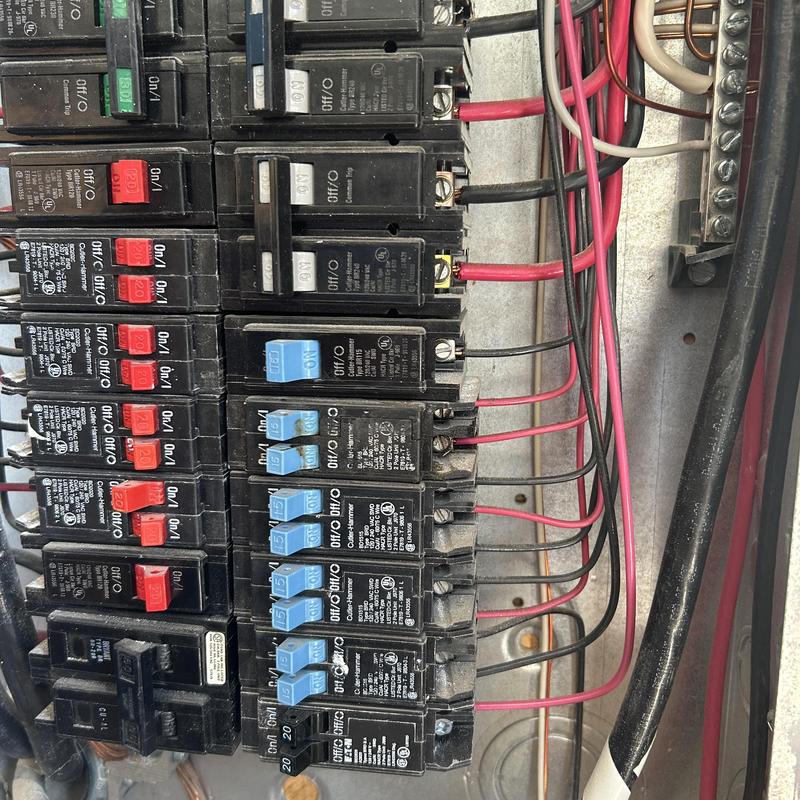 GFCI breakers in main electrical panel with heat damage