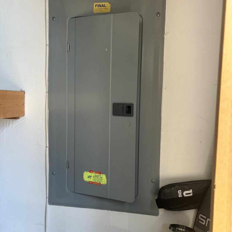 Electrical service panel with heat damage in Boise