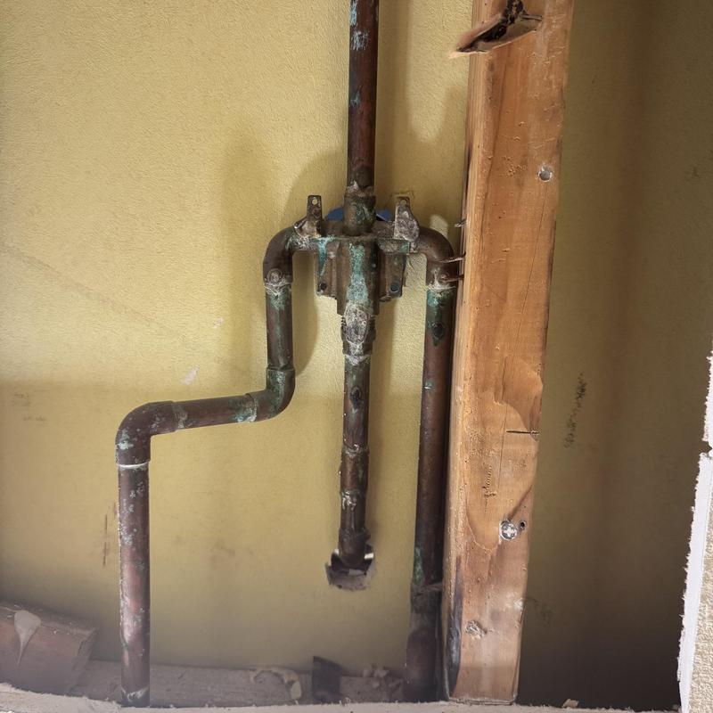 Copper shower valve piping with corrosion buildup Copper shower valve piping with corrosion buildup