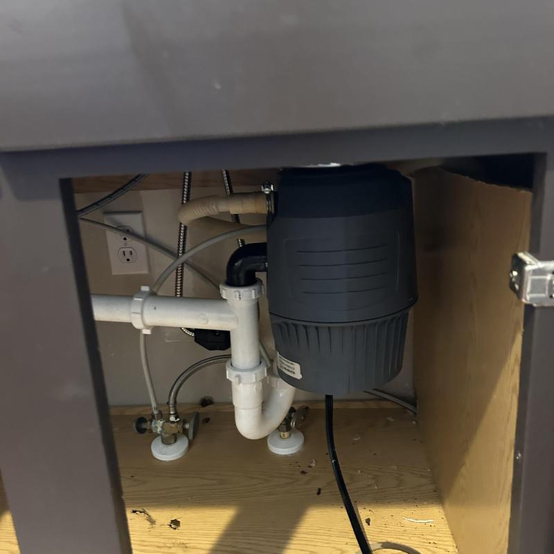 Garbage disposal installed under kitchen sink cabinet Garbage disposal installed under kitchen sink cabinet