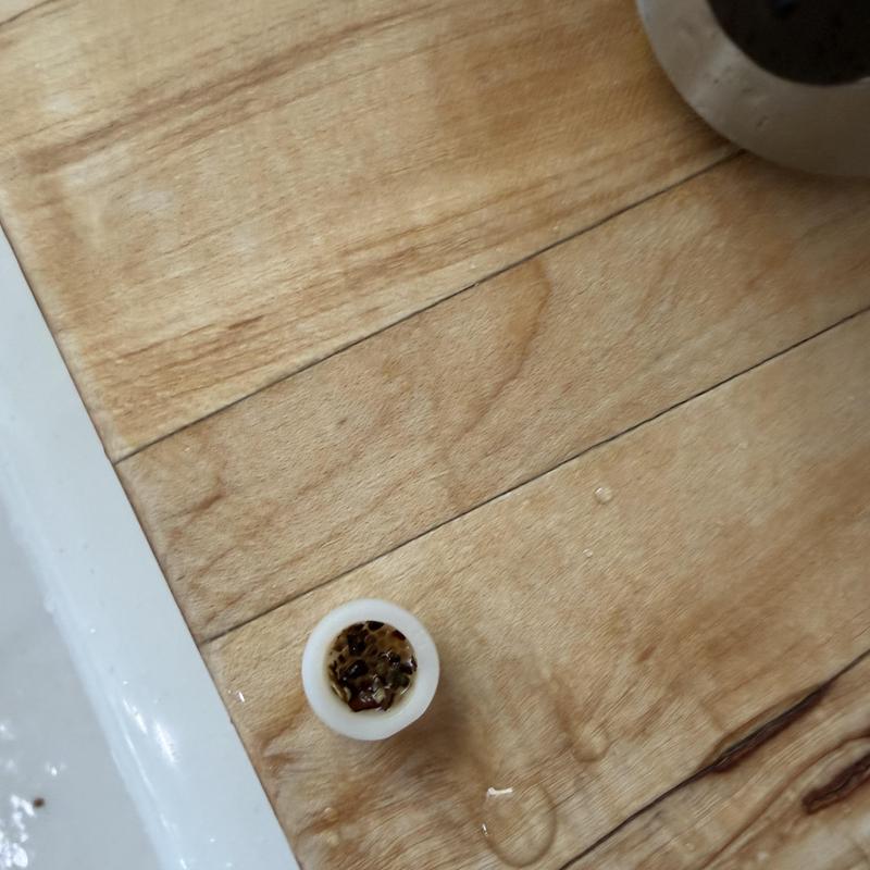 Kitchen faucet aerator with debris buildup Kitchen faucet aerator with debris buildup