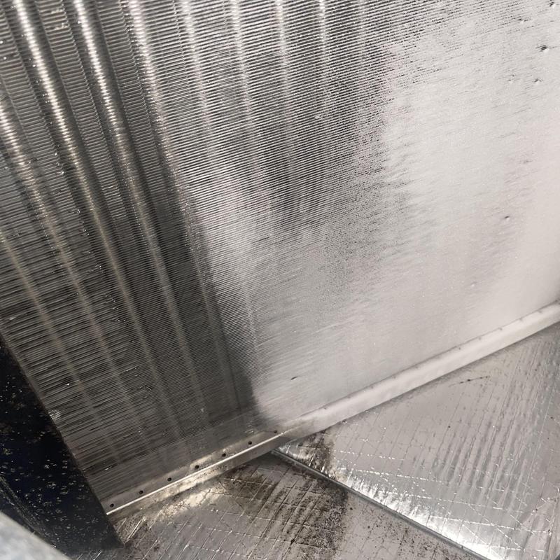 Evaporator coil with melting ice buildup inside air handler Evaporator coil with melting ice buildup inside air handler