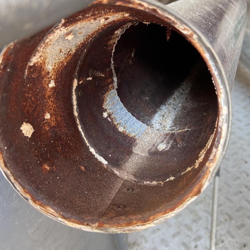 Water heater single wall vent pipe corrosion close-up Water heater single wall vent pipe corrosion close-up