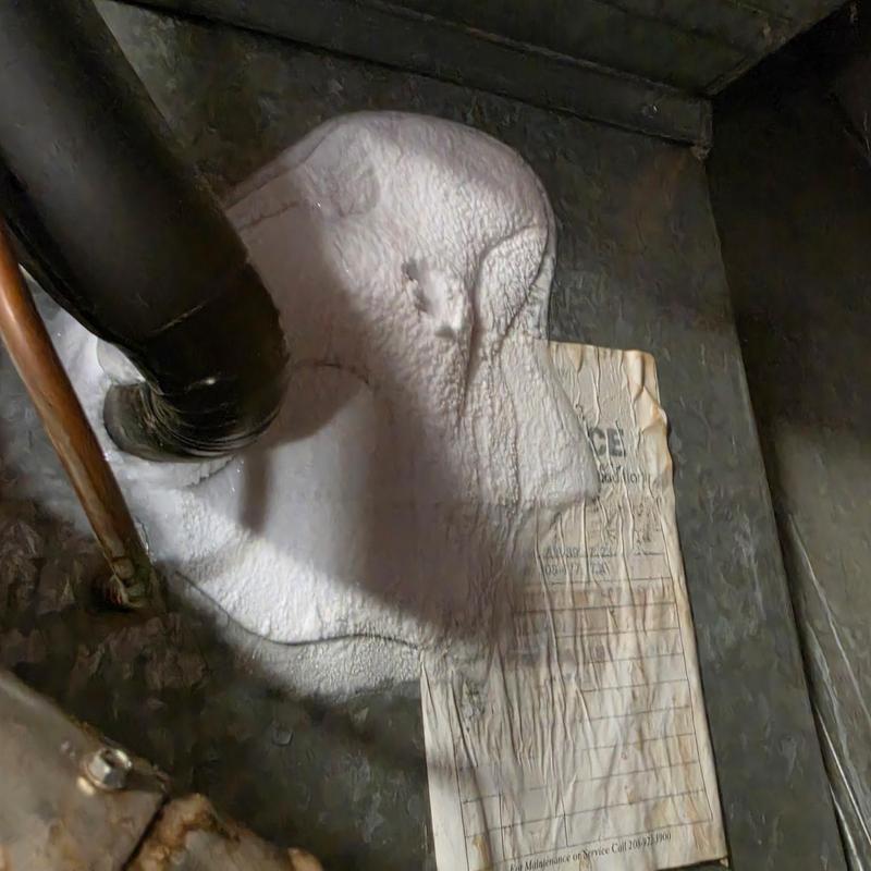 Frozen air conditioner evaporator coil with frost buildup Frozen air conditioner evaporator coil with frost buildup