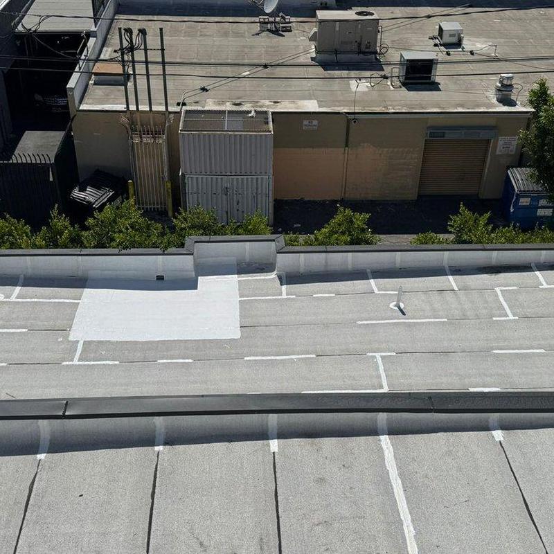 Flat roof with new patch and weatherproofing coating Flat roof with new patch and weatherproofing coating