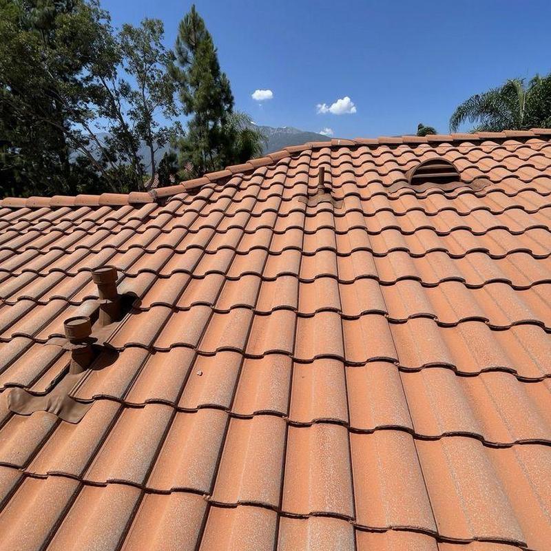 Tile roof with vent pipes and ridge vent in place Tile roof with vent pipes and ridge vent in place