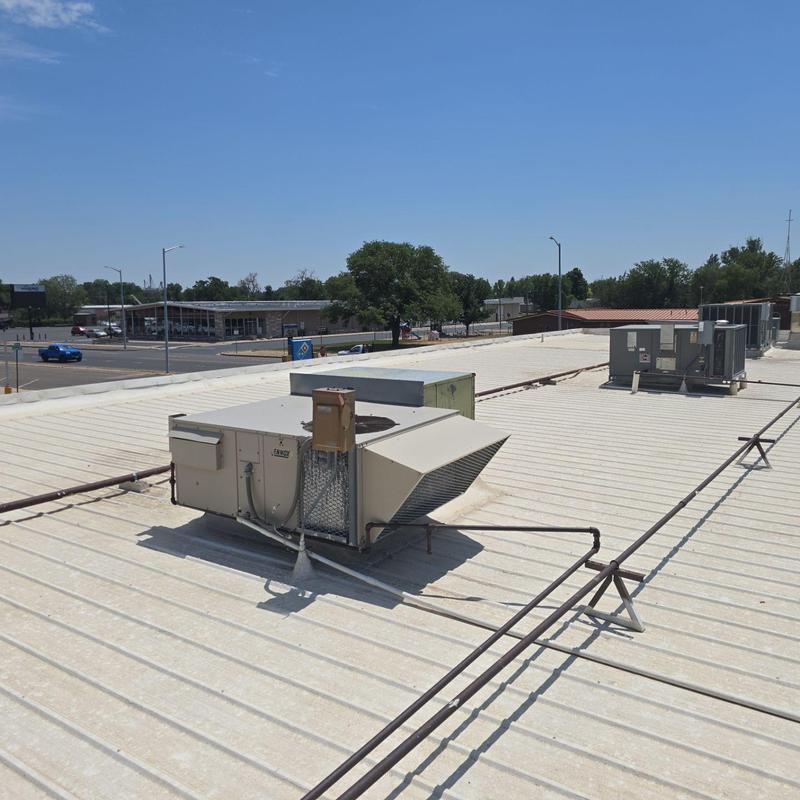 Metal roof with HVAC units and piping on top Metal roof with HVAC units and piping on top