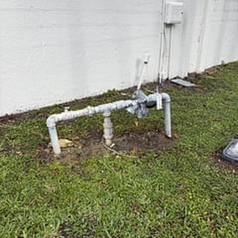 Backflow preventer device with PVC piping outdoors