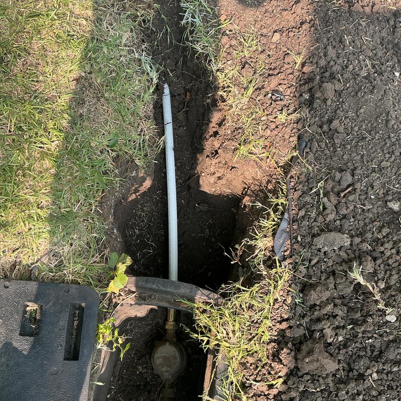 PEX water service line being laid in trench