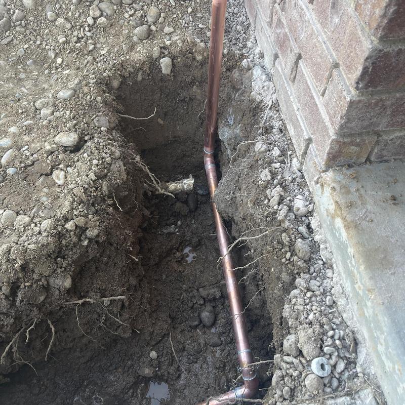 1-inch copper water line underground by brick wall