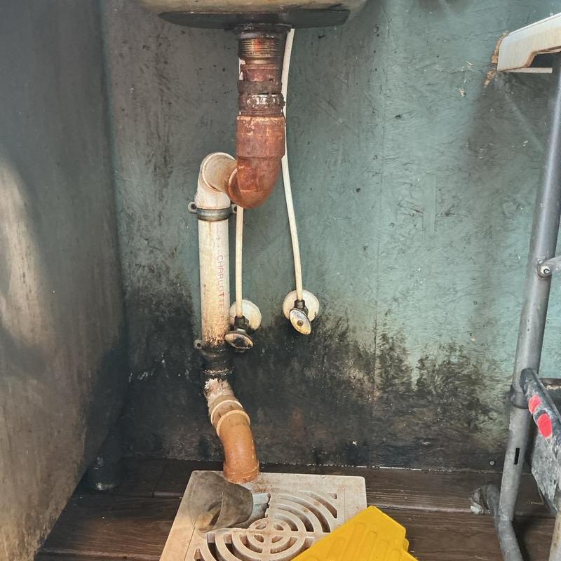 Sink drain pipes with rust and corrosion buildup Sink drain pipes with rust and corrosion buildup